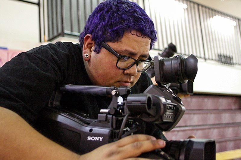 Benjamin Simpson/Courier Gabriel Reyna works a video camera from the top of the stands at the men's and women's basketball games in the Hutto-Patterson Gym, Feb 15, 2013.