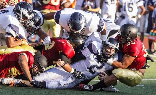Benjamin Simpson/Courier Pasadena’s Kevin Tapia (35), helps bring down Citrus College’s quarterback Larry Cutbirth (2) during Pasadena’s opening home game at Robinson Stadium on Sept, 7, 2013. The Lancers came back from a 24-point deficit against Citrus College to score three touchdowns, but lost with a score of 21-34.