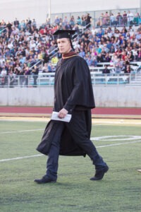 Dustin Lance Black walks onto PCC’s Robinson Field at the beginning of the commencement ceremony on Friday, May 9, 2014. Black’s speech, which received a standing ovation, discussed the “Power of our combined differences.” (Benjamin Simpson/Courier)