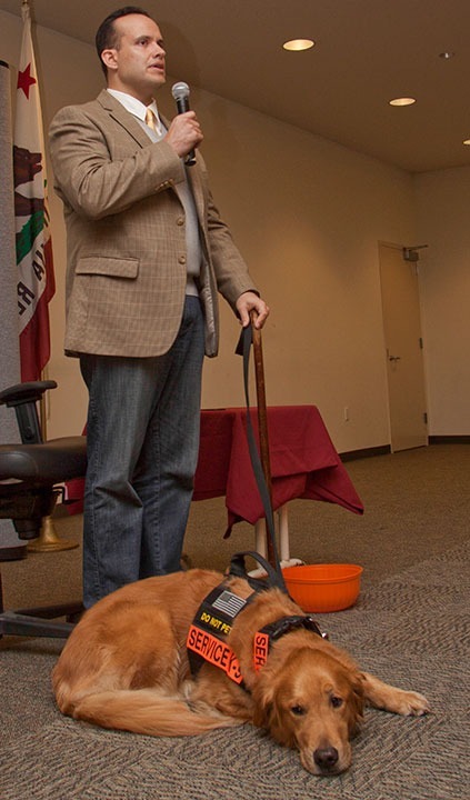 Benjamin SImpson / Courier Luis Carlos Montalván, and his helper dog Tuesday, talk to students at the Creveling Lounge on Sept 17, 2013. Montalván spoke about his 17 years in the military and his bestselling book ‘Until Tuesday: A Wounded Warrier and the Golden Retriever who Saved Him.”