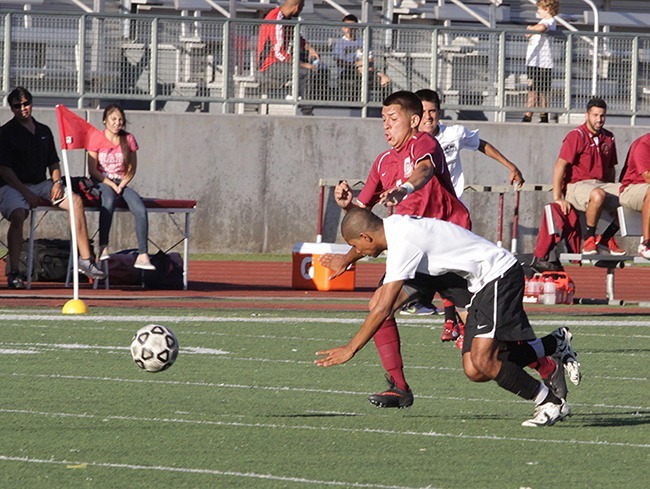 Sergio Benitez cuts past Adam Franco to score the Lancers goal in the 1-1 tie against San Bernardio Valley College at home in Robinson Field on Sept 27. (Courier/Benjamin Simpson)