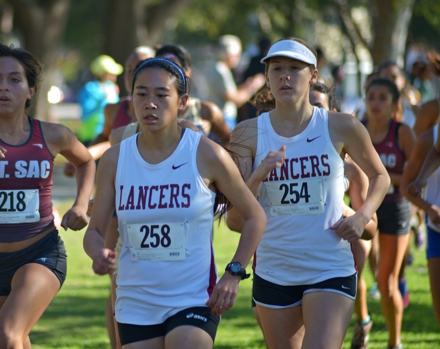 Teresa Mendoza / Courier PCC runners Tansica Sunkamaneevongse and Brenda Grate stay in the top ten during the second lap of the race at the South Coast Conference Championships, Friday at Heartwell Park in Long Beach.