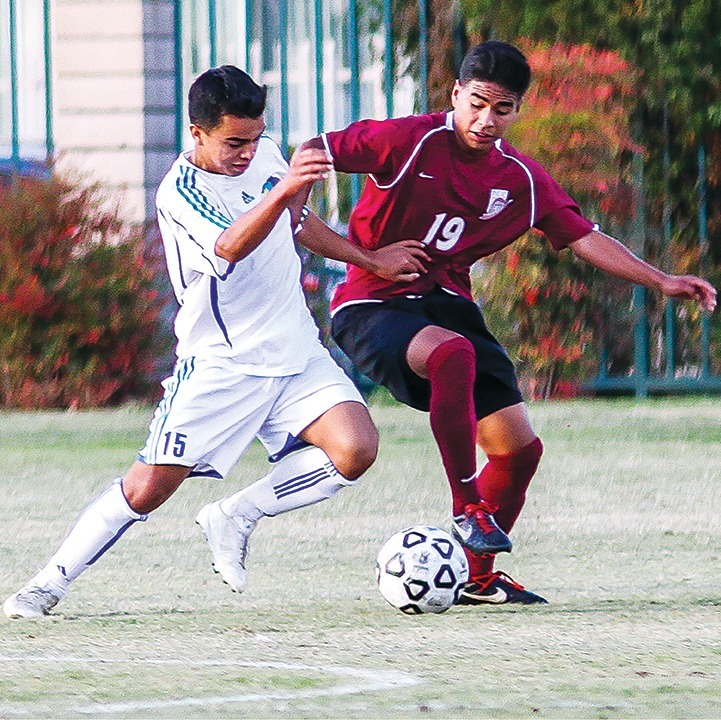 Antonio Gandara/Courier Midfielder Diego Rodriguez battles for the ball against the Condor Defender.